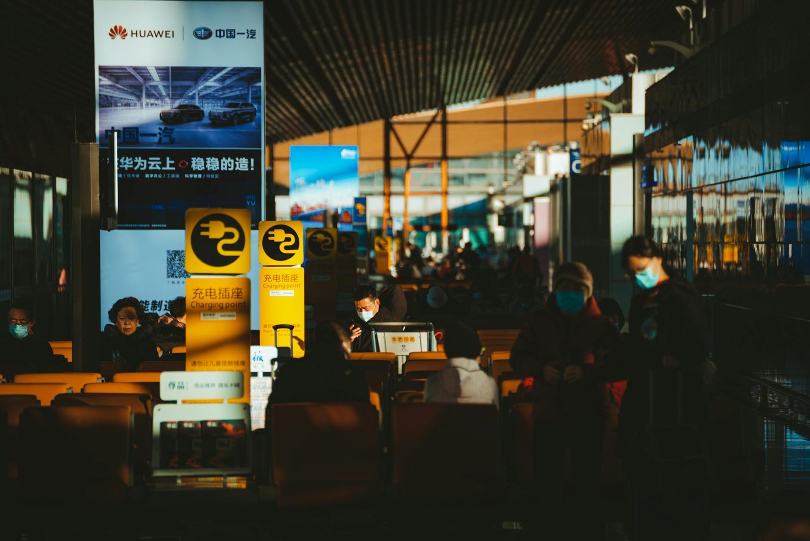 people at an airport lounge wearing face masks