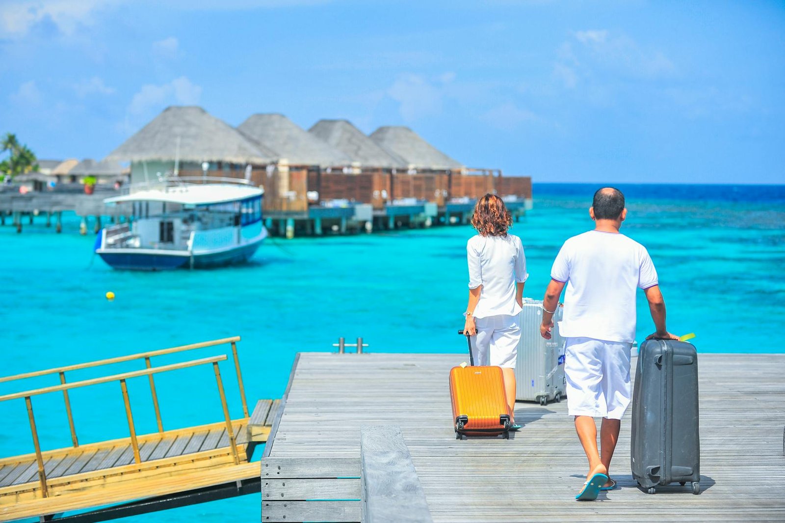 man and woman walks on dock