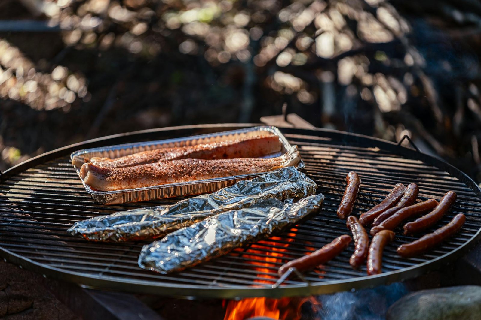 outdoor barbecue grilling sausages and fish
